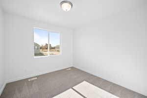 Empty room featuring carpet flooring