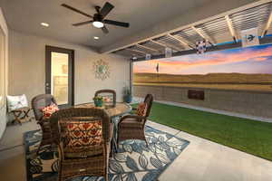 Patio terrace at dusk featuring ceiling fan, a yard, and a pergola