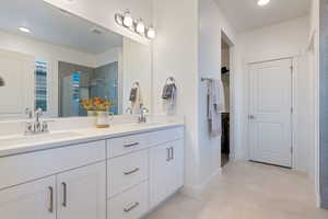 Bathroom featuring walk in shower and vanity