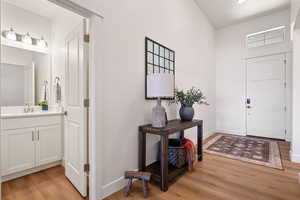 Foyer entrance with sink and light hardwood / wood-style flooring