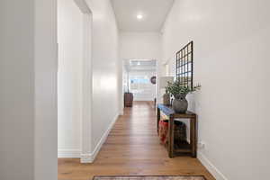 Hall with hardwood / wood-style flooring