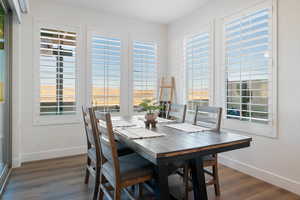 Dining space featuring dark wood-type flooring