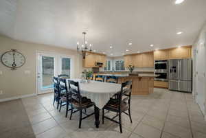 Dining room featuring light tile patterned flooring and a chandelier