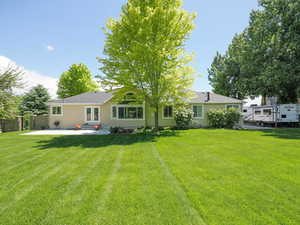 Back of house featuring a patio area and a lawn