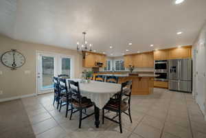 Dining room with an inviting chandelier and light tile patterned floors