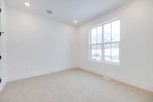 Unfurnished room featuring carpet flooring