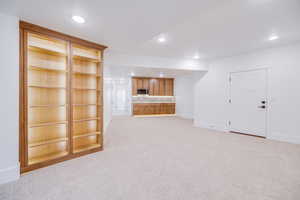 Unfurnished living room with light colored carpet