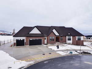 View of front of house featuring a mountain view and a garage