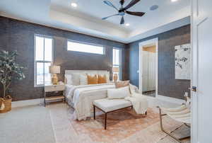 Carpeted bedroom with ceiling fan