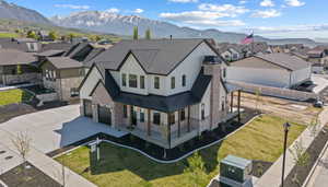 Birds eye view of property with a mountain view and a residential view
