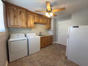 Large laundry room with cabinets, sink & room for 2nd fridge/freezer