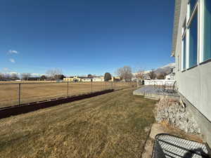 View of yard featuring a deck with mountain view