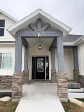 Property entrance featuring covered porch & no step entry