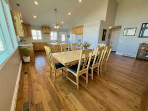 Large dining area with wood floors & vaulted ceilings