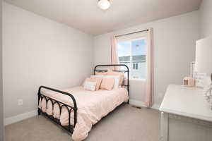 Bedroom with light colored carpet