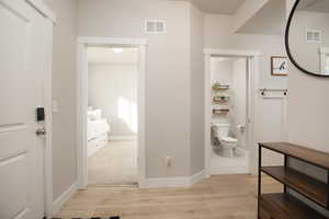 Bathroom featuring hardwood / wood-style floors and toilet