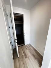 Foyer entrance with light wood-style flooring and baseboards