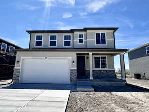 View of front of home with a porch, stucco siding, an attached garage, stone siding, and driveway