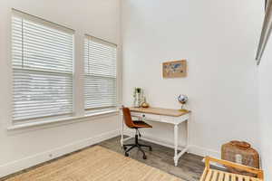 Office space with hardwood / wood-style flooring