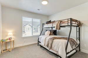 Carpeted bedroom featuring a textured ceiling