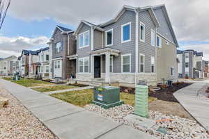 View of front of property with cooling unit