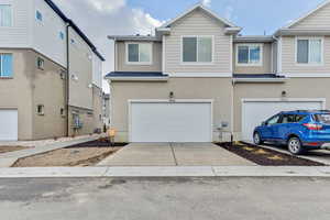 Townhome / multi-family property featuring a garage