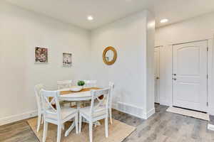 Dining space with wood-type flooring