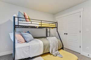 Carpeted bedroom featuring a closet