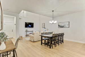 Dining area featuring a notable chandelier and light hardwood / wood-style floors