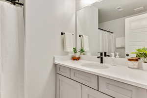 Bathroom with vanity and a textured ceiling