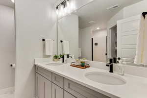 Bathroom featuring vanity and a shower with shower door