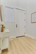 Entrance foyer with light wood-type flooring