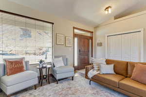 Living room featuring lofted ceiling and light hardwood / wood-style floors