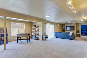 Interior space featuring rail lighting and a textured ceiling