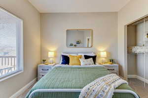 Bedroom featuring carpet and a closet