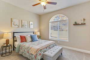 Carpeted bedroom with ceiling fan