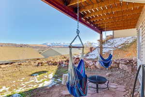 View of patio with a mountain view and a fire pit