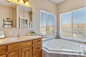 Bathroom with vanity and a relaxing tiled tub