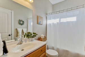 Bathroom featuring vanity, a healthy amount of sunlight, and toilet