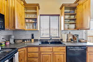 Kitchen featuring sink, backsplash, and dishwasher