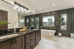 Bathroom featuring vanity, a wealth of natural light, and independent shower and bath