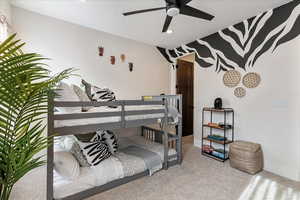 Bedroom featuring light colored carpet