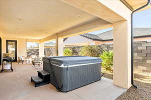 View of patio with a hot tub