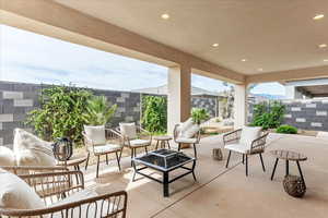 View of patio with an outdoor fire pit