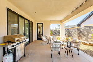 View of patio with a grill