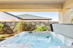 Exterior space with a hot tub