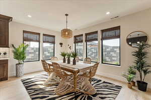 Dining area with light hardwood / wood-style flooring