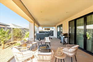 View of patio / terrace with a grill and a hot tub