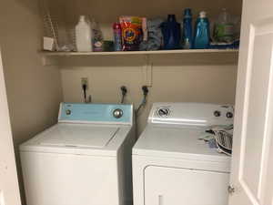 Clothes washing area featuring washing machine and dryer