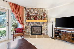 Carpeted living room featuring a fireplace